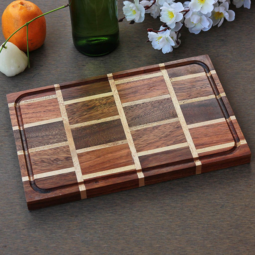 A brick pattern wooden cheese board made with walnut and birch wood.