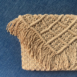 A brown handcrafted macrame clutch handbag with fringed detailing