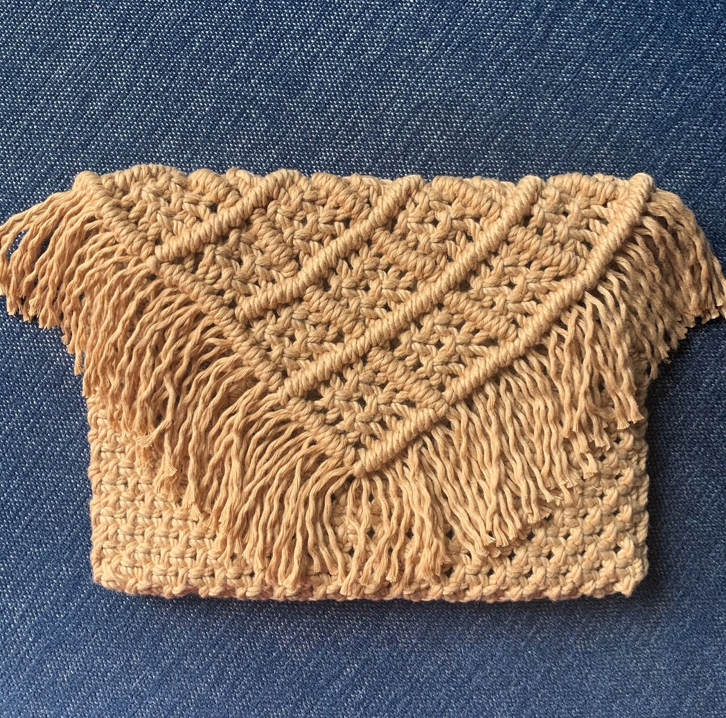 A brown handcrafted macrame clutch handbag with fringed detailing
