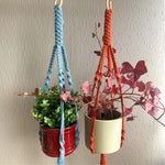 Load image into Gallery viewer, A blue and a orange macrame plant hanger with indoor plants in a maroon pot and a green planter hanging from the ceiling
