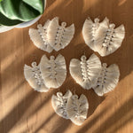 Load image into Gallery viewer, Five pairs of white macrame fringed feather earrings that will add a bohemian touch to your outfit.
