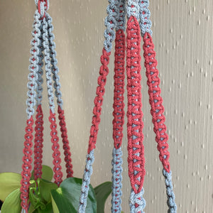 A close up shot of macrame knots on blue and maroon two-toned macrame plant hangers