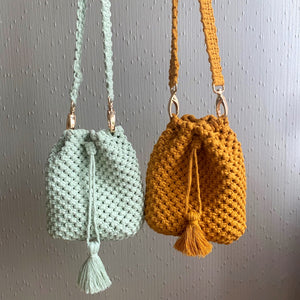 Two macrame bucket bags with drawstring closure in mustard yellow and mint green colour