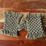 Load image into Gallery viewer, A set of 4 beige macrame tea and coffee coasters.
