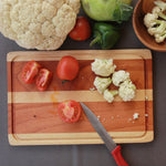 Load image into Gallery viewer, Chopped tomatoes and cauliflower florets on a mahogany wood and birch wood striped chopping board
