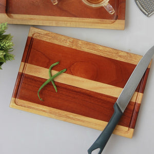 A striped mahogany and birch wood cutting board and cheese board 