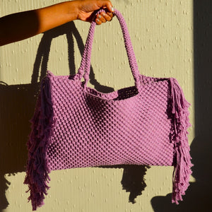 A lavender coloured handcrafted beach bag with fringe detailing