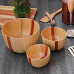 Load image into Gallery viewer, A set of 3 wooden handmade bowls in birchwood with a black sirish wood accent in 3 sizes - large, medium and small.
