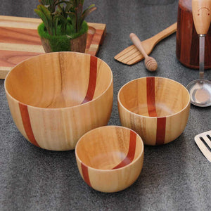 A set of 3 wooden handmade bowls in birchwood with a black sirish wood accent in 3 sizes - large, medium and small.
